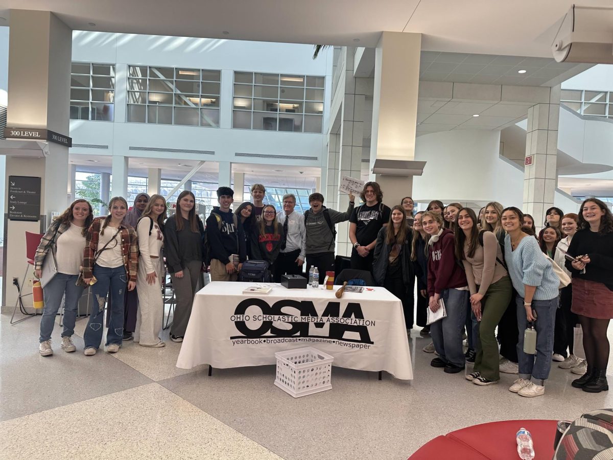 Members of the Lakota East Spark pose at the Region 3 workshop with their retired adviser, Dean Hume.